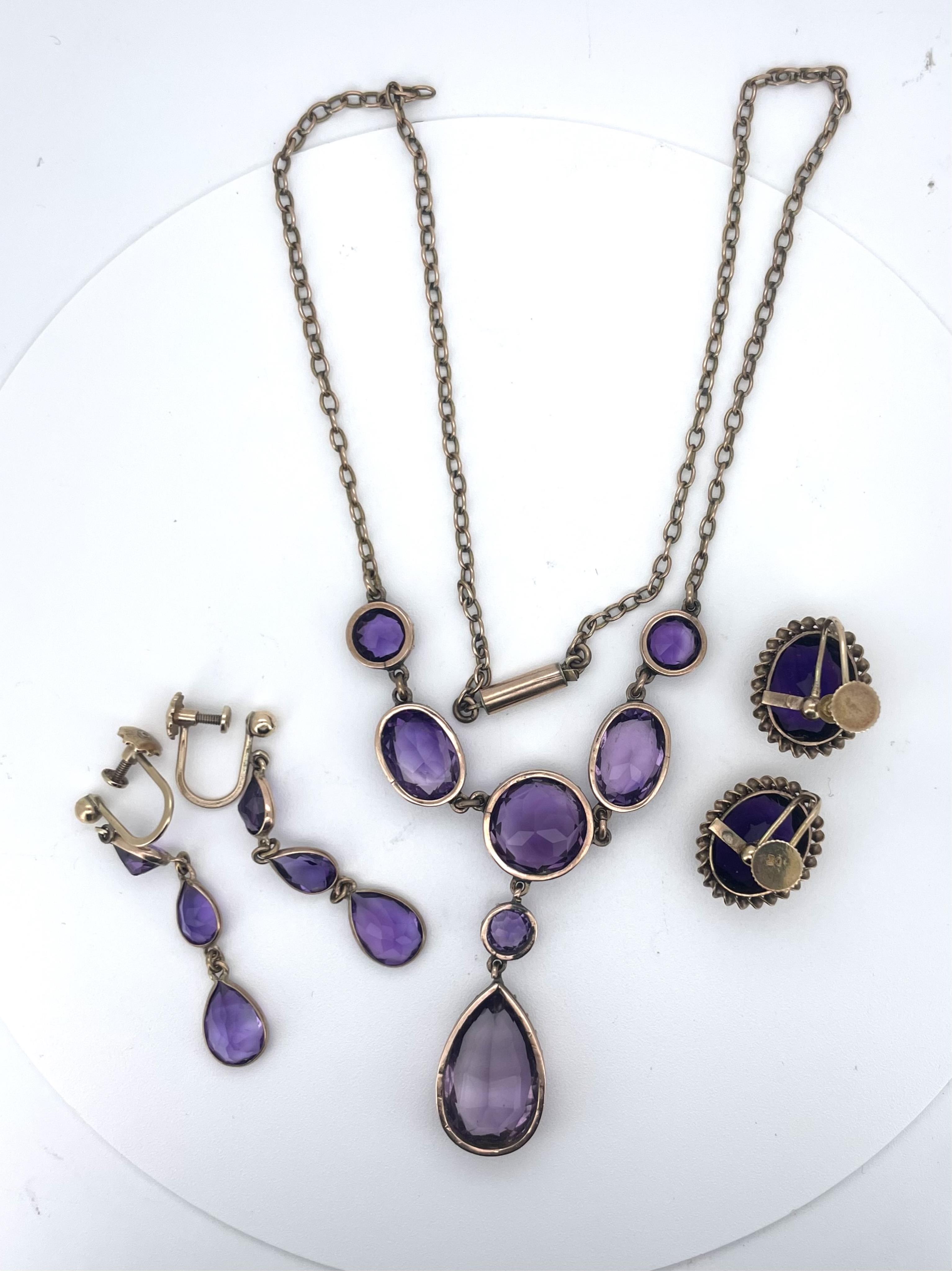 An amethyst necklace and two pairs of earrings, comprising: a Victorian necklace, the front composed of circular-cut and oval amethysts in pinched collet settings, suspending a pear-shaped amethyst pendant, to a plain go